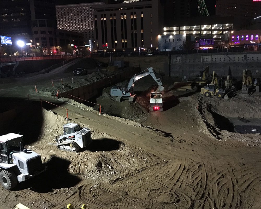Excavators and Bulldozers on Site of the Block 23 Project at Night